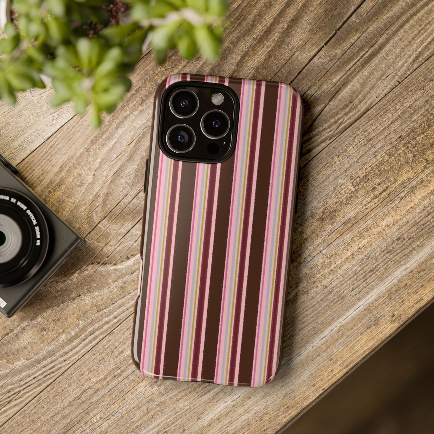 Brown and pink vertical striped iPhone tough case with retro vintage aesthetic on iPhone Pro model
